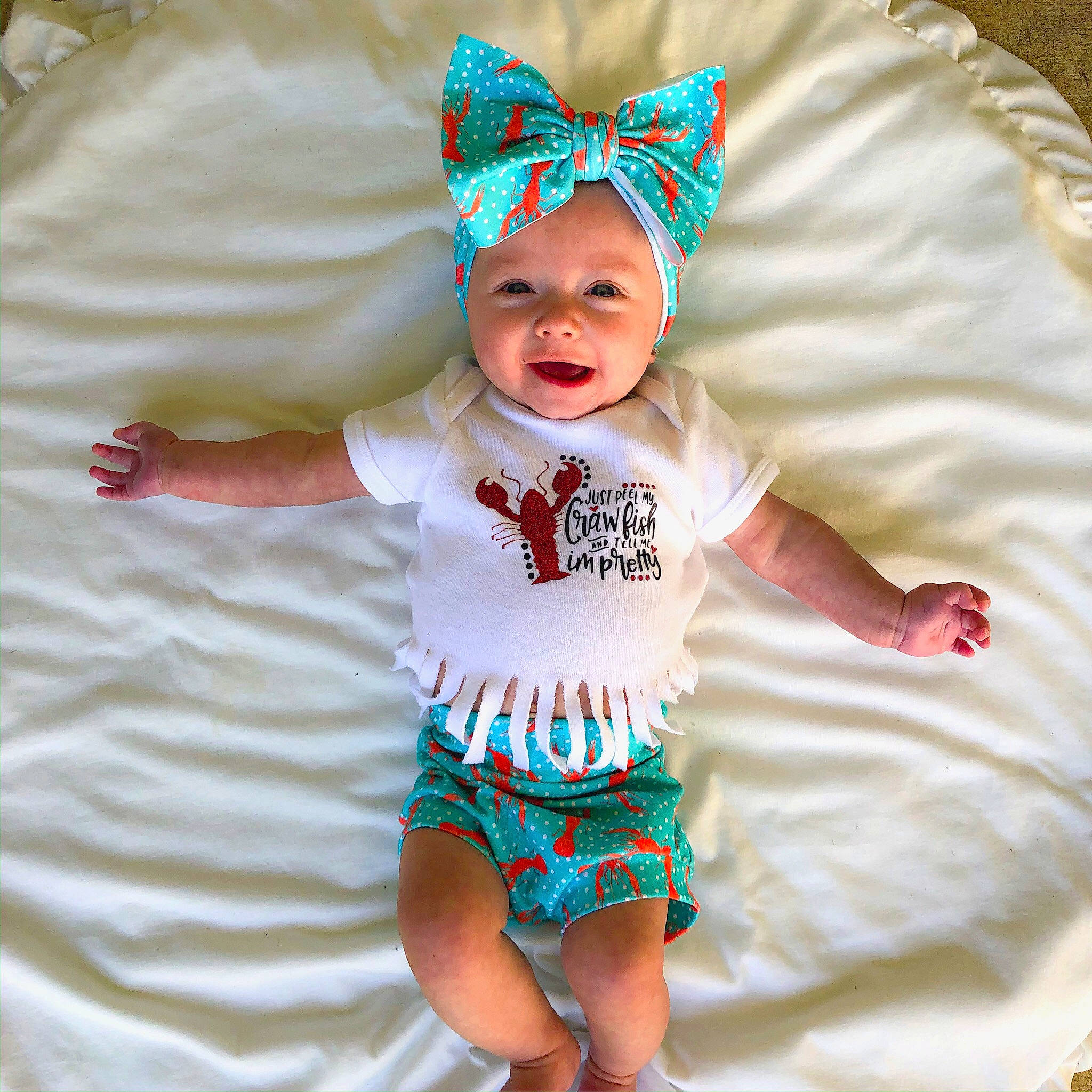 Emersyn joined the competition — help win amazing prizes! baby, baby_bloomers, baby_products, baby_toddler_clothing, child, costume_accessory, diaper, fashion_accessory, green, hair_accessory, head, headgear, headwear, pattern, person, product, sleeve, smile, t_shirt, toddler