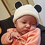 Taëlyna a rejoint le concours — aidez-le/la à gagner de superbes lots ! baby, infant, hat, clothing, pink, face, hand, cute, sleepy, indoors, person, portrait, soft, warm, cozy, newborn, headwear, expression, comfort, child