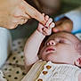 baby, care, closeup, clothing, comfort, cozy, finger, hand, holding, infant, intimate, love, peaceful, person, skin, sleeping, soft_focus, tender, touch, wooden_buttons