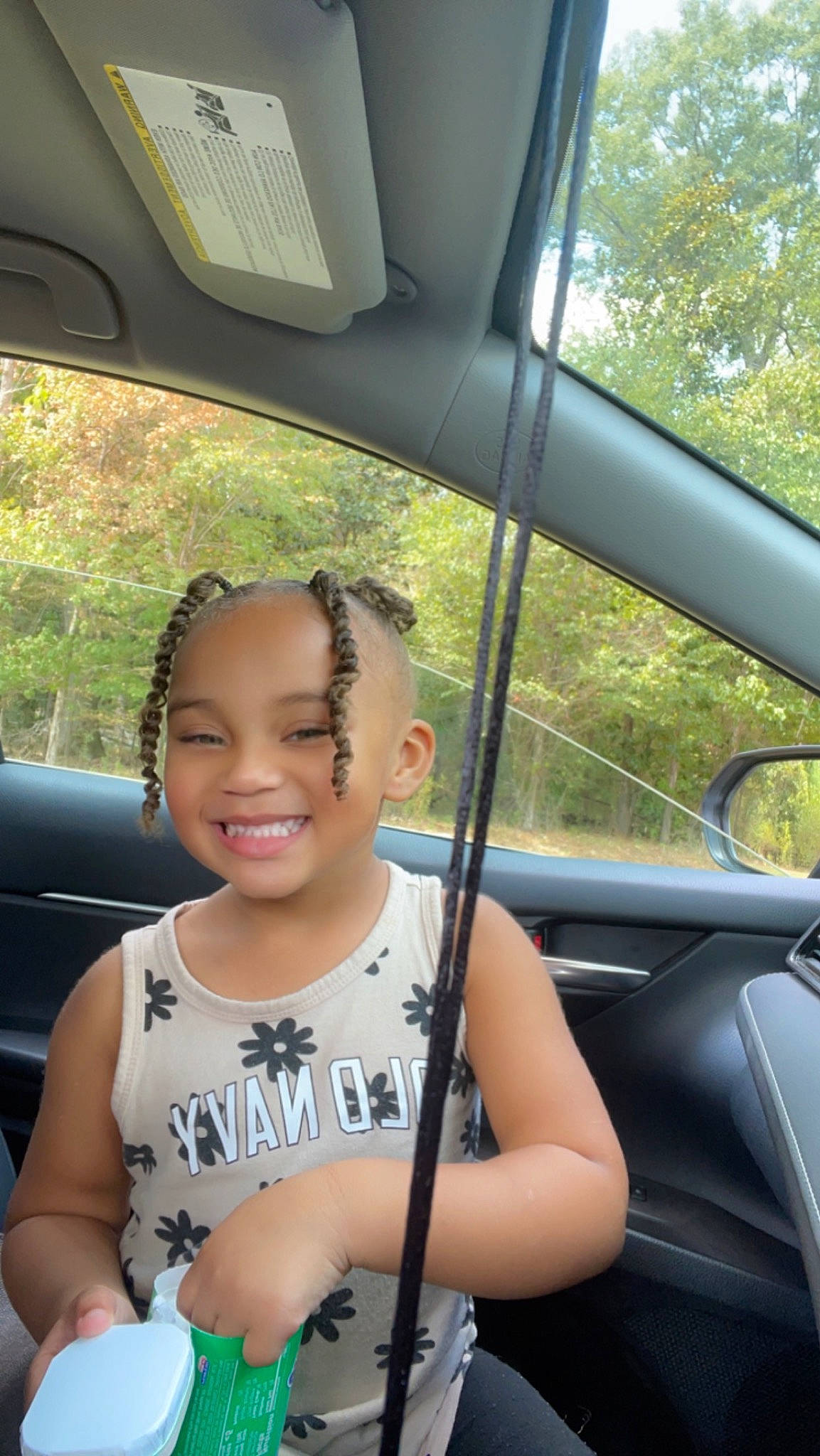 Addison is registered to the contest to win money with this photo: auto_part, automotive_design, automotive_exterior, automotive_lighting, automotive_mirror, car, car_seat, finger, happy, joy, leisure, mode_of_transport, motor_vehicle, person, plant, rear_view_mirror, smile, travel, tree, vehicle