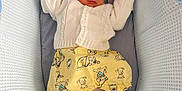 Joshua is registered to the contest to win money with this photo: baby, bassinet, child, cozy, cute, cute_clothing, dog_pattern, indoors, infant, newborn, peaceful, person, resting, sleep, sleeping, small, soft, textured, white_sweater, yellow_pants