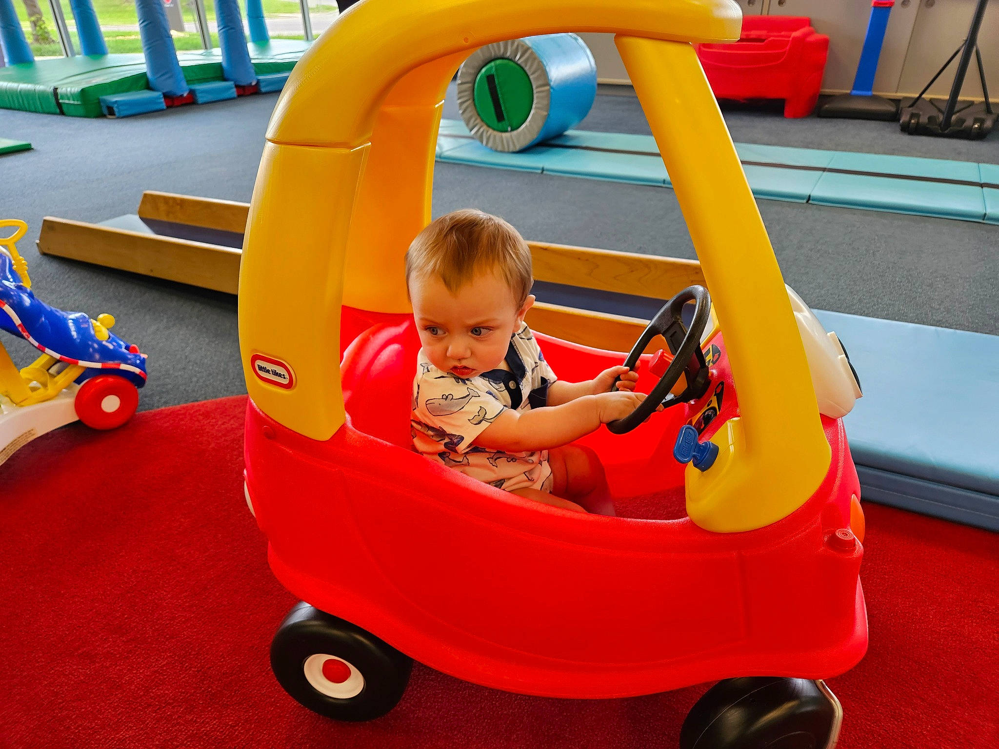 Czar is registered to the contest to win money with this photo: baby, baby_products, baby_toddler_clothing, child, city, comfort, fun, leisure, motor_vehicle, person, play, recreation, riding_toy, shorts, sitting, snapshot, tire, toddler, vehicle, wheel