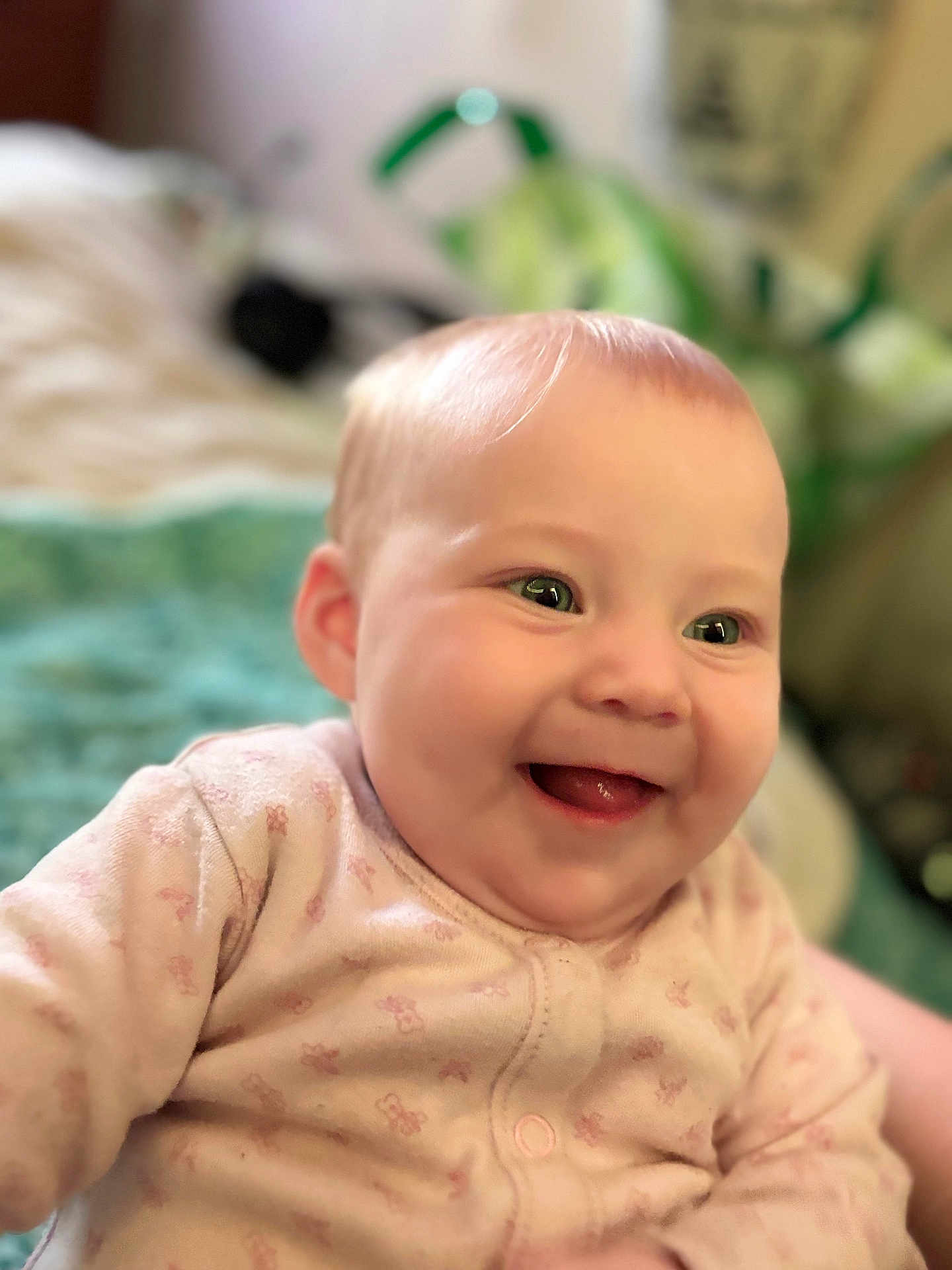 Imogen is registered to the contest to win money with this photo: baby, infant, smile, happy, face, child, onesie, pink_clothing, indoor, portrait, cute, soft_focus, young_child, baby_girl, cheerful, warm_lighting, closeup, eyes, skin, adorable