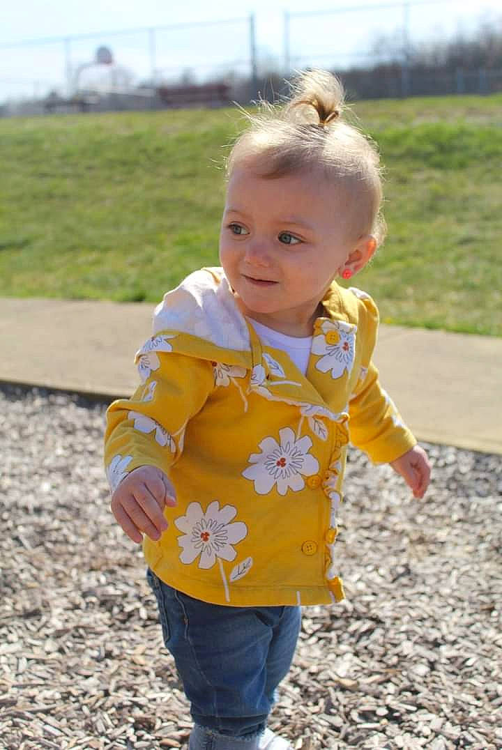 Arianna is registered to the contest to win money with this photo: baby, baby_toddler_clothing, child, eye, fun, grass, happy, jeans, leaf, leisure, people_in_nature, person, plant, pumpkin, recreation, sleeve, smile, standing, t_shirt, toddler