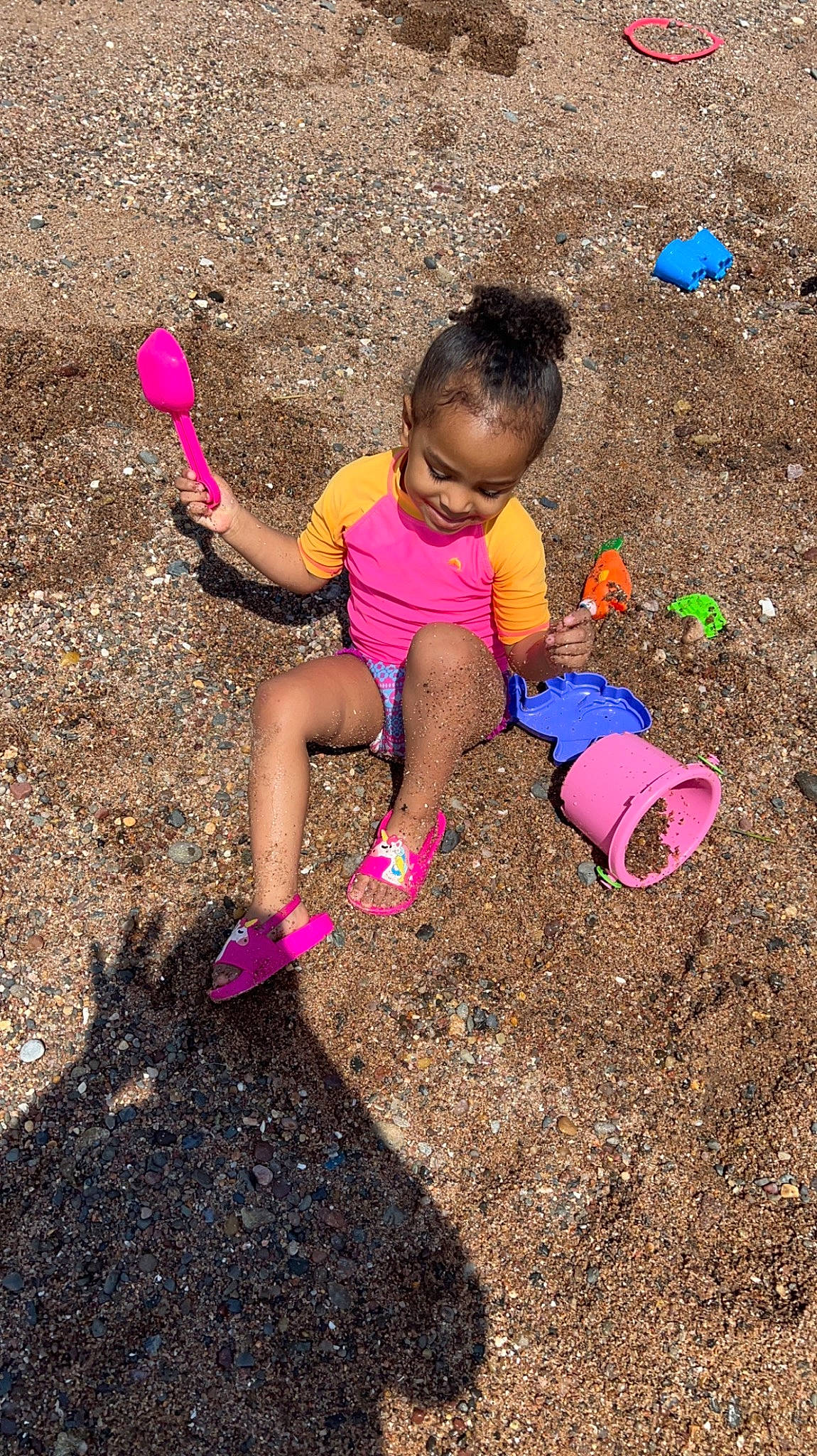 Ahlani joined the competition — help win amazing prizes! asphalt, child, foot, fun, grass, happy, human_leg, leg, leisure, magenta, people_in_nature, person, pink, road_surface, shadow, sitting, sneakers, soil, thigh, toddler