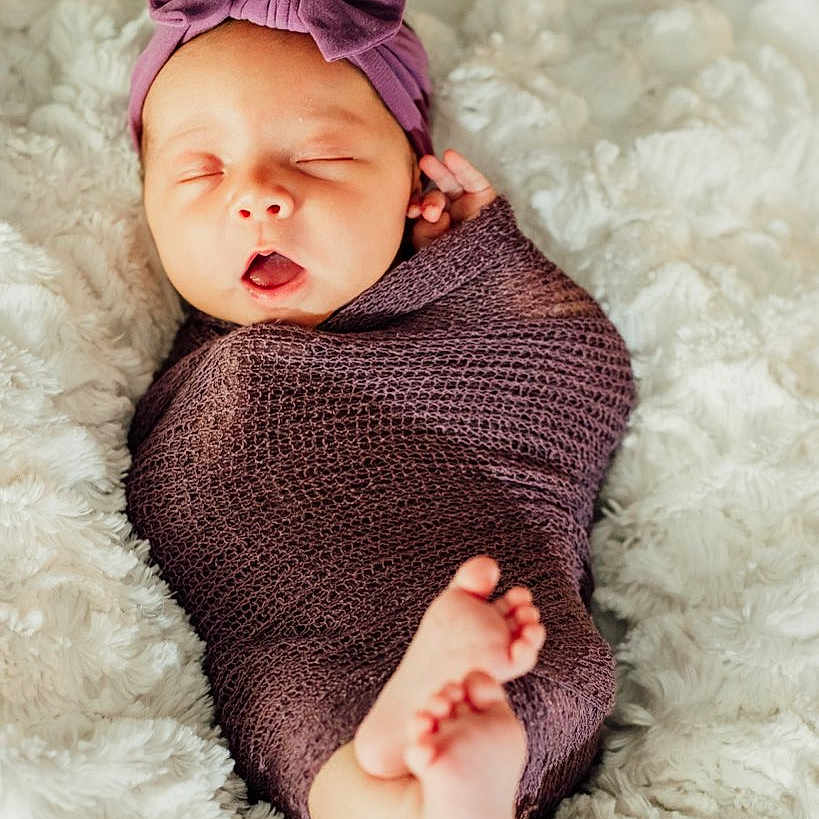 Alayla joined the competition — help win amazing prizes! baby, blanket, clothing, face, head, knitwear, newborn, person, photography, portrait, sleeping, sweater, yawning