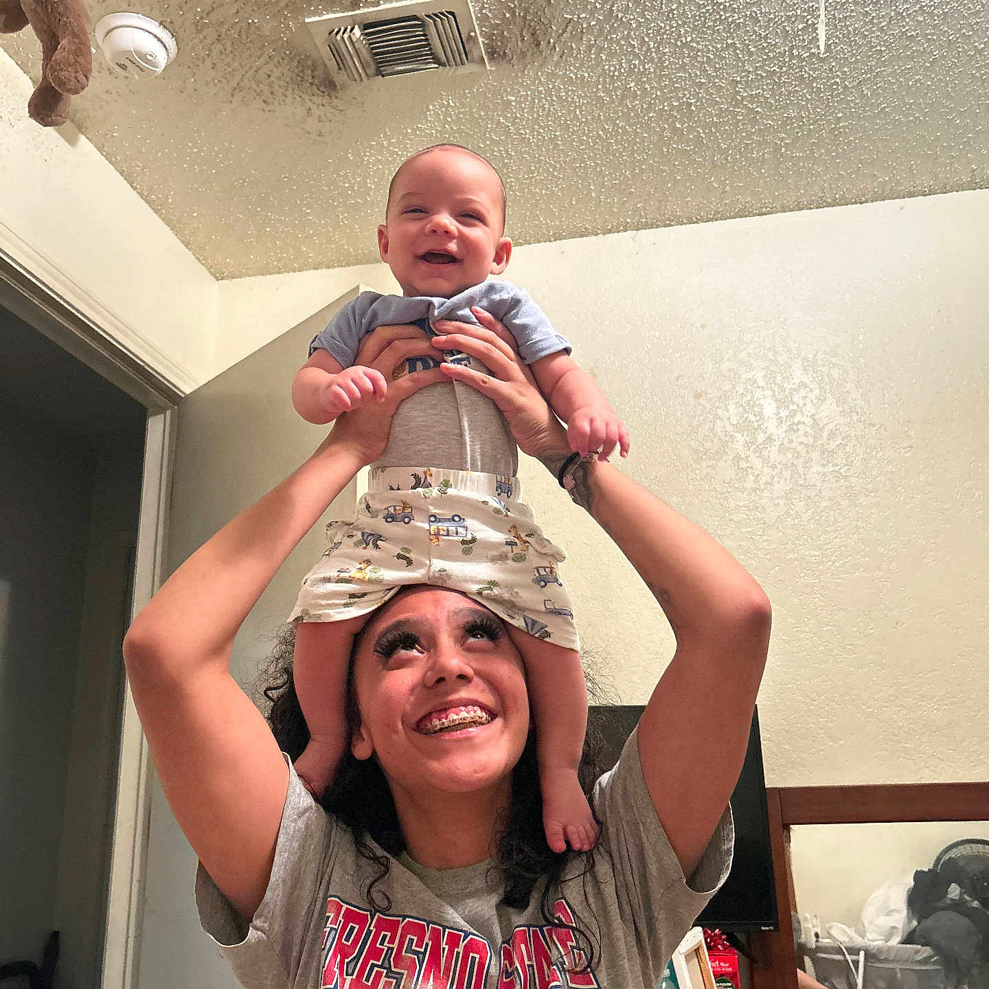 Copper is registered to the contest to win money with this photo: animal, architecture, baby, bear, building, clothing, face, furniture, happy, hat, head, indoors, livingroom, pants, people, person, photography, portrait, smile, t_shirt