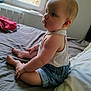 Mya participe au concours pour gagner de l'argent avec cette photo : baby, child, infant, sitting, bed, denim_shorts, white_top, indoors, window, natural_light, soft_light, skin, face, legs, feet, hands, curtains, room, cozy, portrait