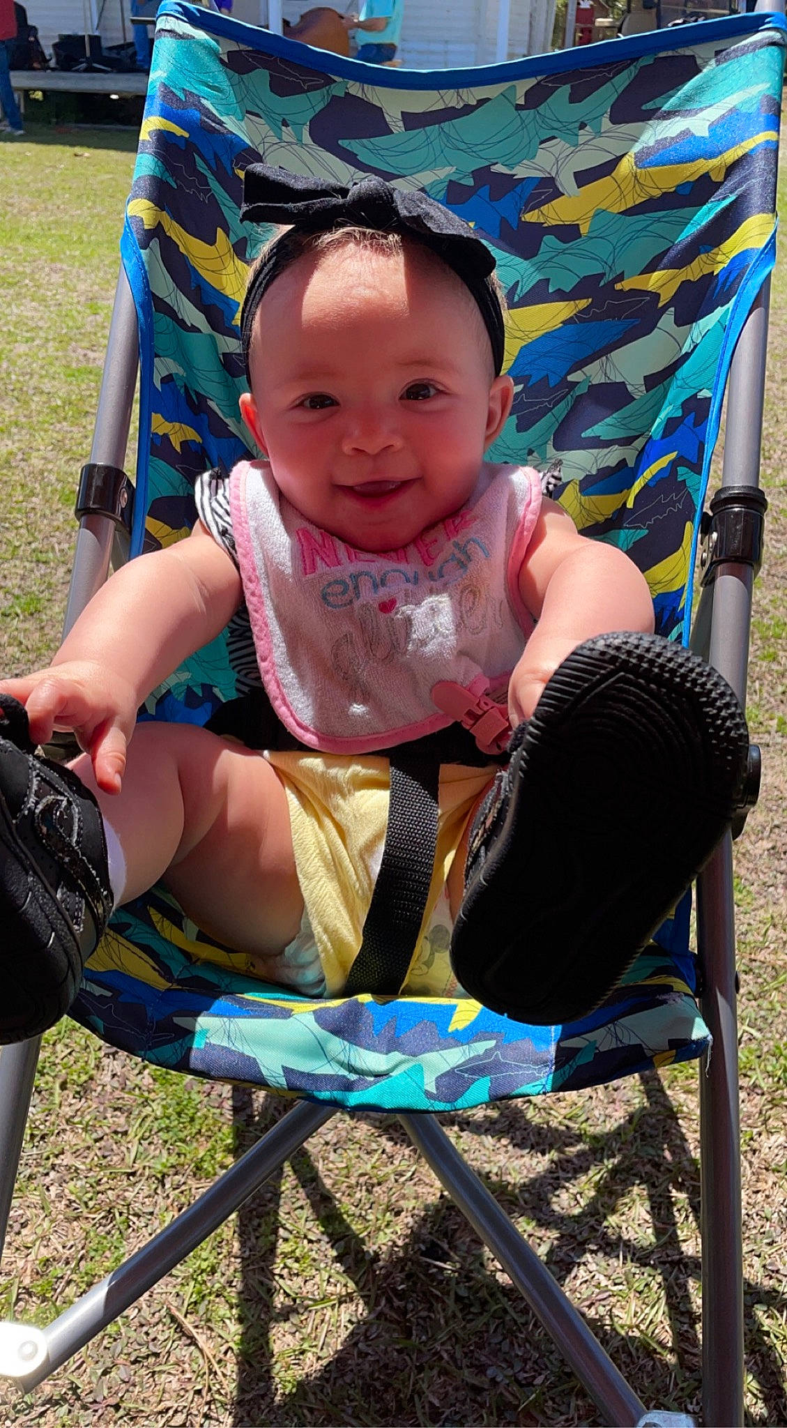 Gracelyn is registered to the contest to win money with this photo: baby, baby_toddler_clothing, blue, chair, child, face, fun, grass, happy, joy, leaf, leisure, outdoor_furniture, person, photograph, product, public_space, recreation, shorts, smile