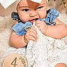 baby, infant, child, headband, bow, denim, overalls, fabric, chewing, milestone, sign, wooden, blanket, cute, sitting, portrait, closeup, indoors, soft_texture, white