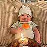 Desmond Dos is registered to the contest to win money with this photo: baby, birthday, cake, calendar_blocks, candle, celebration, chocolate_cake, clothing, cushion, cute, face, happy, hat, indoor, infant, number_2, orange_graphic, person, smile, texture