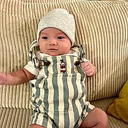 Desmond Dos joined the competition — help win amazing prizes! baby, beige, butterfly_illustration, child, clothing, couch, cute, framed_art, furniture, hat, home, indoor, infant, portrait, potted_plant, relaxing, ribbed_texture, sitting, smile, striped_clothing
