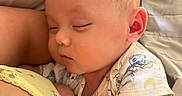 Desmond Dos is registered to the contest to win money with this photo: arm, baby, cartoon_print, clothing, comfort, cozy, cute, face, head, human, indoors, infant, light, peaceful, portrait, resting, skin, sleeping, toddler, young