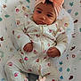 Lydia-Lyy is registered to the contest to win money with this photo: baby, infant, headband, bow, onesie, patterned_clothing, baby_seat, cute, child, indoor, portrait, face, hands, feet, fabric, soft_toys_pattern, pink, white, floral_pattern, relaxing