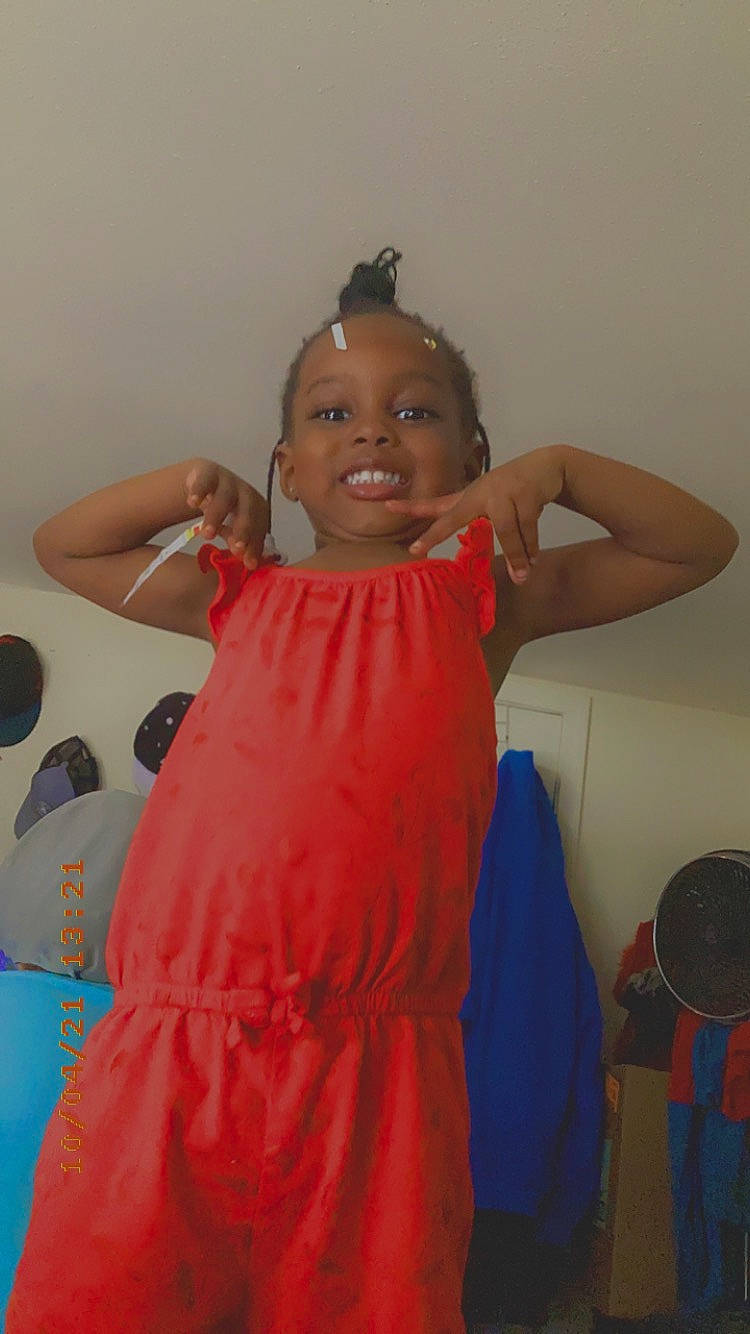 Kymani is registered to the contest to win money with this photo: arm, child, event, fashion_design, formal_wear, fun, hairstyle, happy, joint, long_hair, magenta, mechanical_fan, organ, person, room, shoulder, sitting, skin, smile, toddler