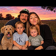 Lynx joined the competition — help win amazing prizes! family, children, adults, dog, pet, portrait, outdoor, sunset, field, rural, group_photo, smiling, happy, sitting, casual_clothing, parent, siblings, curly_hair, nature, photography