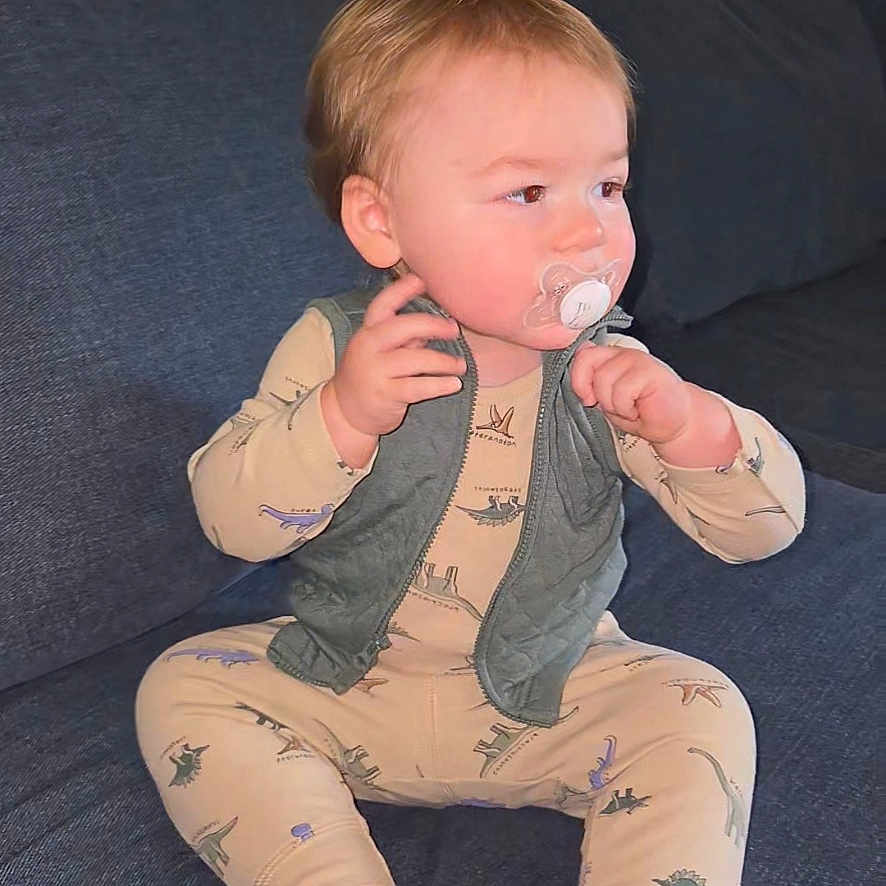 Waylan joined the competition — help win amazing prizes! baby, child, infant, sitting, sofa, couch, pacifier, vest, pajamas, bare_feet, blond_hair, face, portrait, indoors, home, furniture, textile, calm, curious, photography