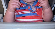 Waylan is registered to the contest to win money with this photo: baby, baby_food, blue_clothing, child, eyes, face, hair, hands, happy, high_chair, indoor, kitchen, messy_tray, portrait, red_clothing, sitting, smiling, striped_shirt, toast, toddler