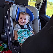 Waylan joined the competition — help win amazing prizes! baby, child, car, car_seat, smiling, happy, sitting, infant, blanket, toy, vehicle, indoors, road_trip, sunlight, countryside, window, seatbelt, portrait, family, travel