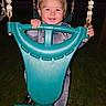 Waylan is registered to the contest to win money with this photo: child, toddler, swing, playground, outdoor, evening, smiling, happy, portrait, face, blond_hair, hands, gripping, bucket_swing, teal, grass, backyard, twilight, flash_photography, playtime