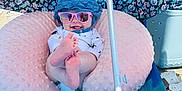 Lakelyn joined the competition — help win amazing prizes! baby, beach_chair, blue, child, feet, floral_pattern, footwear, hat, neck_pillow, outdoor, pink, playful, relaxation, sandals, smile, summer, sun_protection, sunglasses, umbrella, vacation