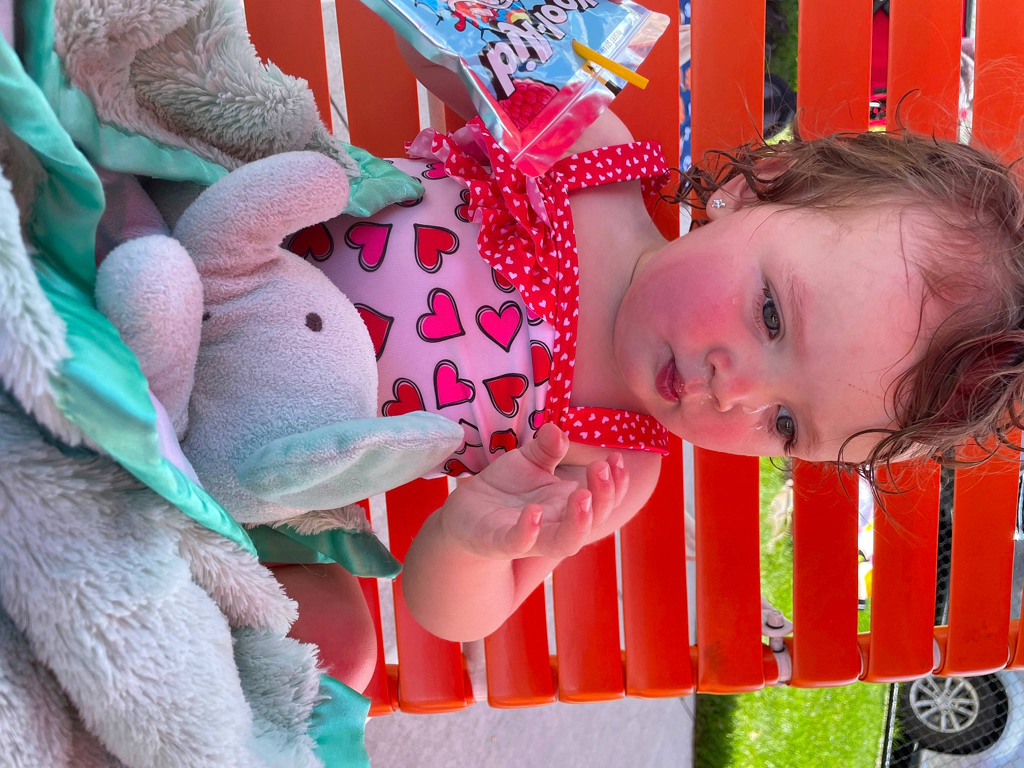 Lillian is registered to the contest to win money with this photo: baby, baby_toddler_clothing, child, eye, fun, happy, head, human_body, leisure, mouth, pattern, person, pink, product, skin, smile, tire, toddler, toy, tree