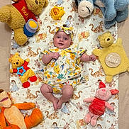 Bonnie joined the competition — help win amazing prizes! baby, child, plush_toy, winnie_the_pooh, piglet, tigger, eeyore, stuffed_animal, blanket, headband, floral_clothing, smiling, lying_down, cute, soft_toys, indoors, colorful, happy, childrens_toy, portrait
