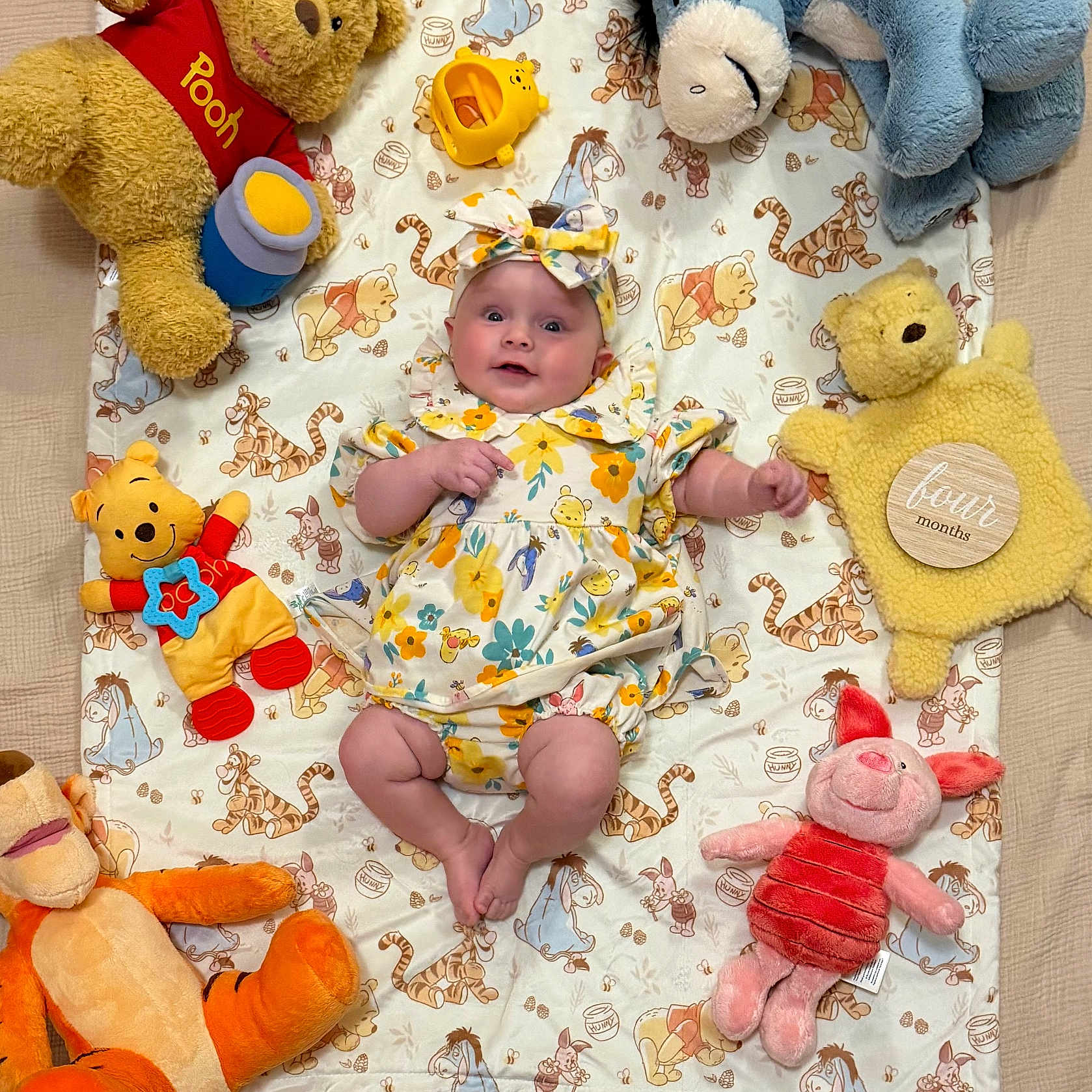 Bonnie joined the competition — help win amazing prizes! baby, child, plush_toy, winnie_the_pooh, piglet, tigger, eeyore, stuffed_animal, blanket, headband, floral_clothing, smiling, lying_down, cute, soft_toys, indoors, colorful, happy, childrens_toy, portrait