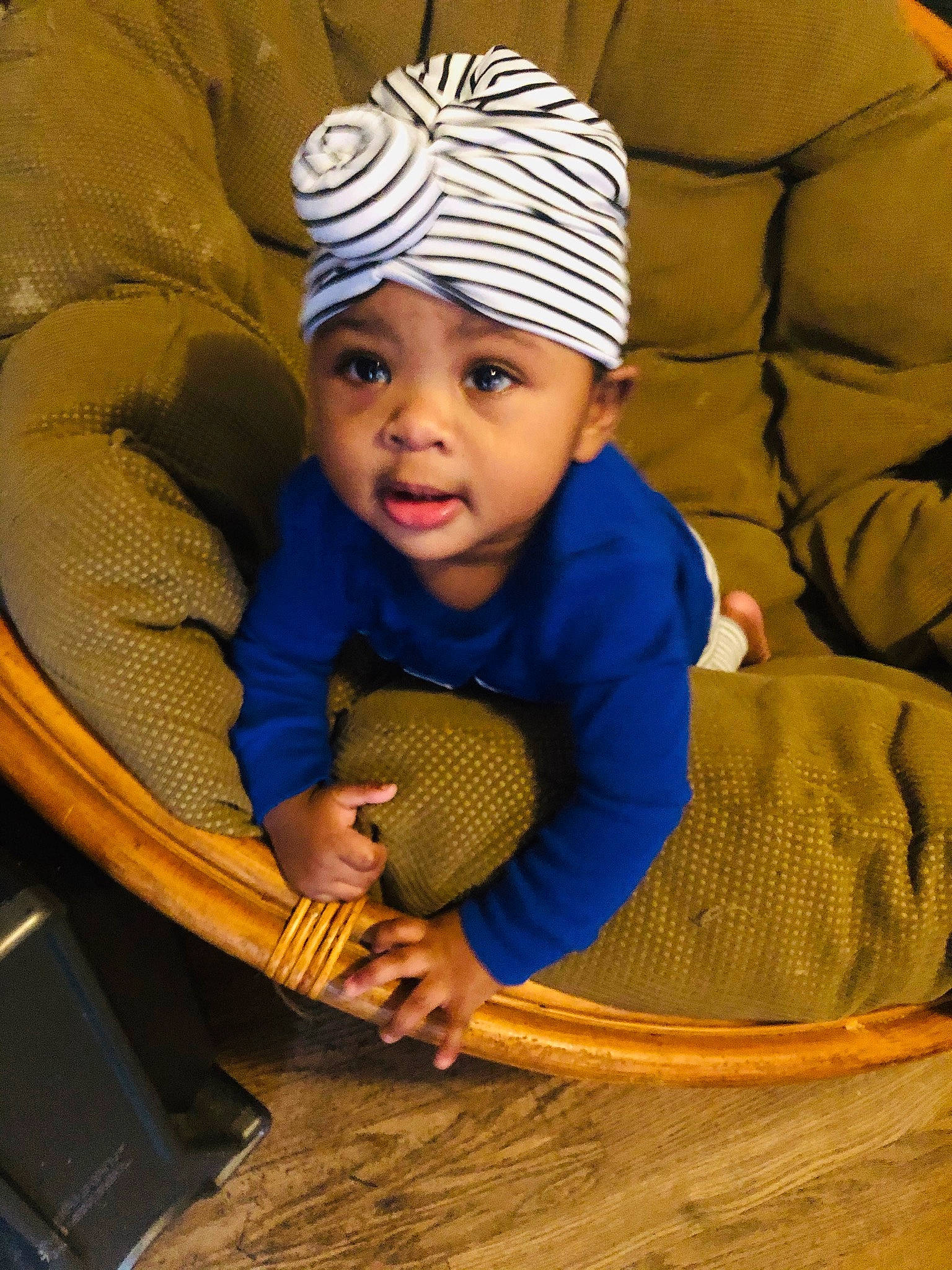 Katrina joined the competition — help win amazing prizes! baby, beanie, cap, chair, child, comfort, fashion_accessory, flooring, fun, headgear, headwear, knit_cap, linens, person, room, sitting, skin, toddler, wicker, wood