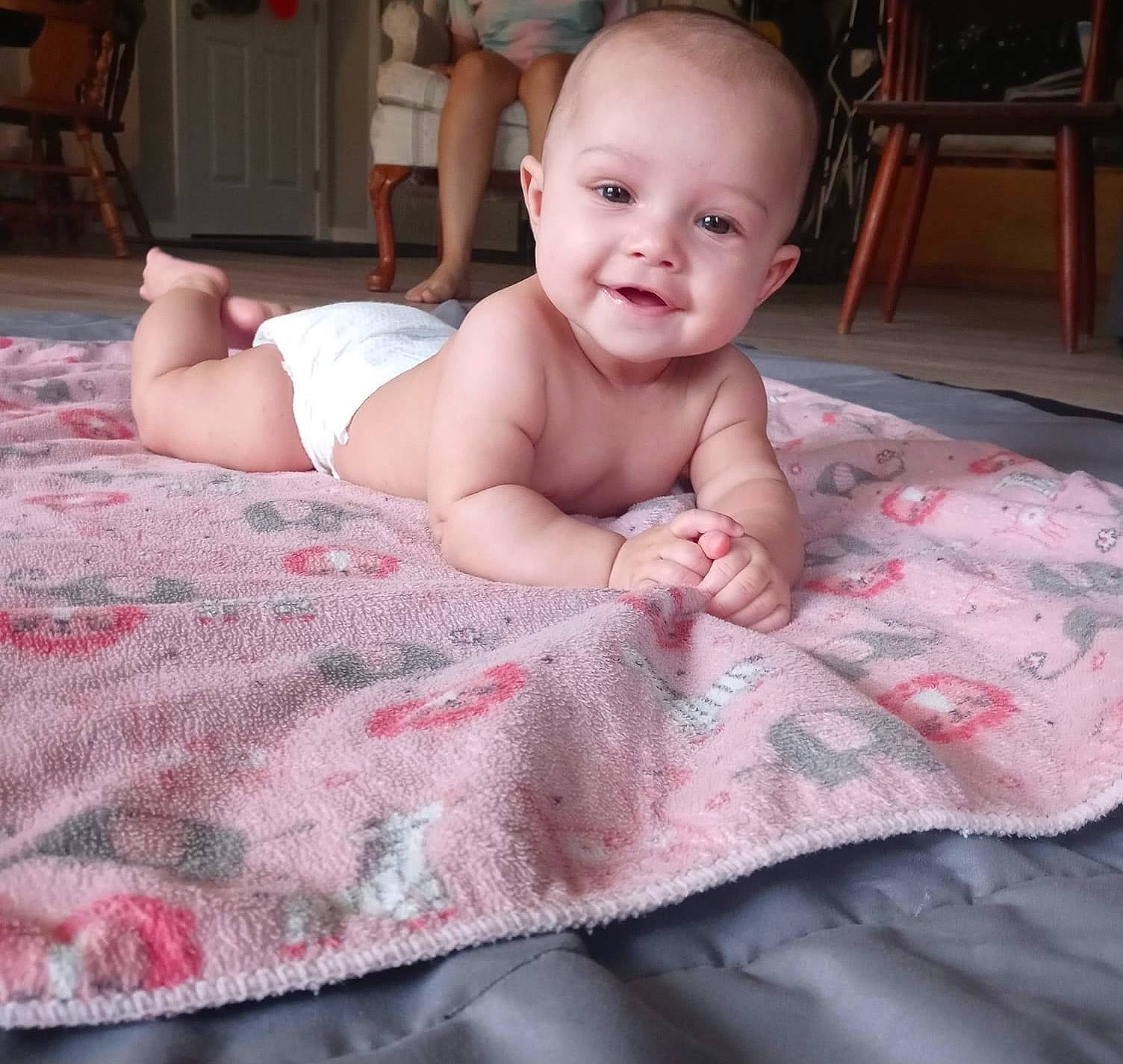 Mazikeen joined the competition — help win amazing prizes! baby, baby_toddler_clothing, bedding, chair, cheek, child, comfort, flooring, happy, iris, joy, linens, pattern, person, pink, room, sitting, skin, smile, textile