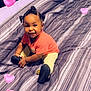 baby, child, smiling, sitting, bed, striped_bedspread, indoor, hair_buns, pink_shirt, yellow_pants, shoes, happy, cute, portrait, heart_emojis, cozy, room, playful, infant, young_child