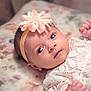 baby, infant, face, headband, flower, lace, clothing, blanket, portrait, cute, newborn, skin, eyes, expression, lying_down, soft, adorable, human, child, indoors