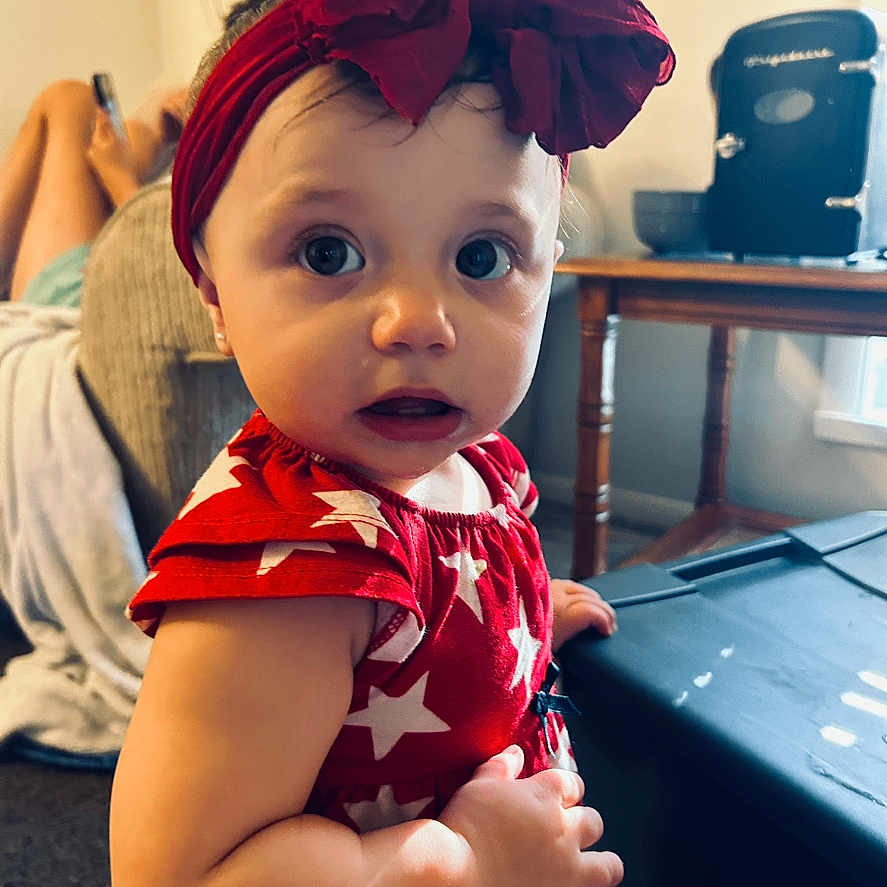 Patience is registered to the contest to win money with this photo: accessories, adult, baby, bodypart, clothing, couch, dress, face, female, finger, formalwear, furniture, hand, hat, head, person, photography, portrait, turban, woman