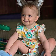 Skyler is registered to the contest to win money with this photo: animal_ears, baby, blue_eyes, carpet, casual, child, colorful_clothing, cute, happy, headband, indoor, infant, person, playful, portrait, sitting, smile, socks, toddler, toy