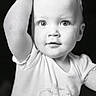 toddler, child, baby, portrait, black_and_white, face, eyes, expression, curious, toy, hand, short_sleeve, clothing, innocence, close_up, person, young_child, cute, smile, indoor