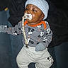 Zymeir joined the competition — help win amazing prizes! baby, child, pacifier, clothing, hat, knit_hat, mickey_mouse, onesie, pants, socks, indoor, lying_down, cute, infant, face, person, dark_background, soft_lighting, gloves, baby_accessory