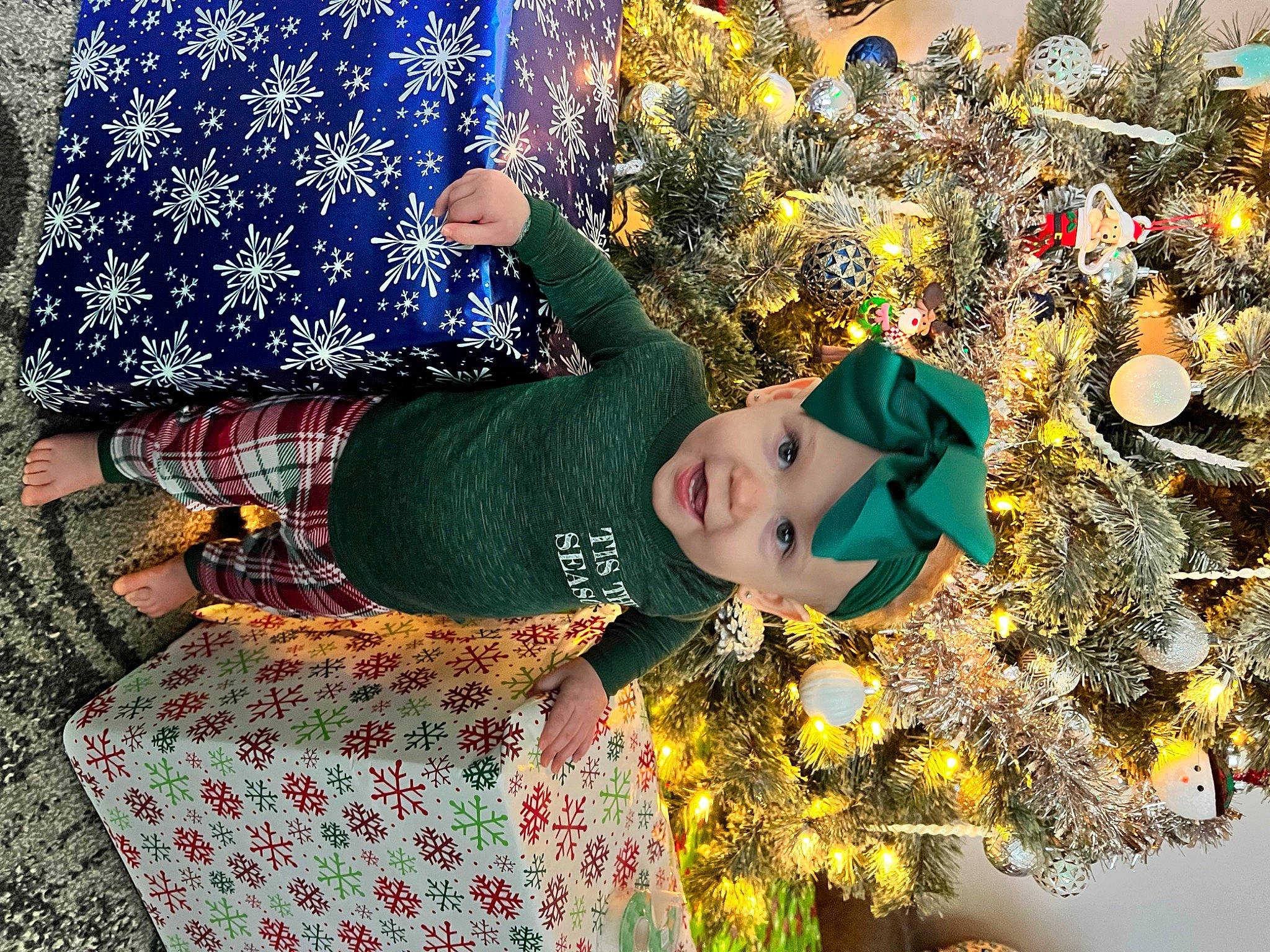 Ansley joined the competition — help win amazing prizes! christmas, christmas_decoration, christmas_eve, christmas_ornament, christmas_tree, doll, event, fun, grass, happy, hat, headwear, holiday, holiday_ornament, ornament, pattern, people_in_nature, person, plant, toddler