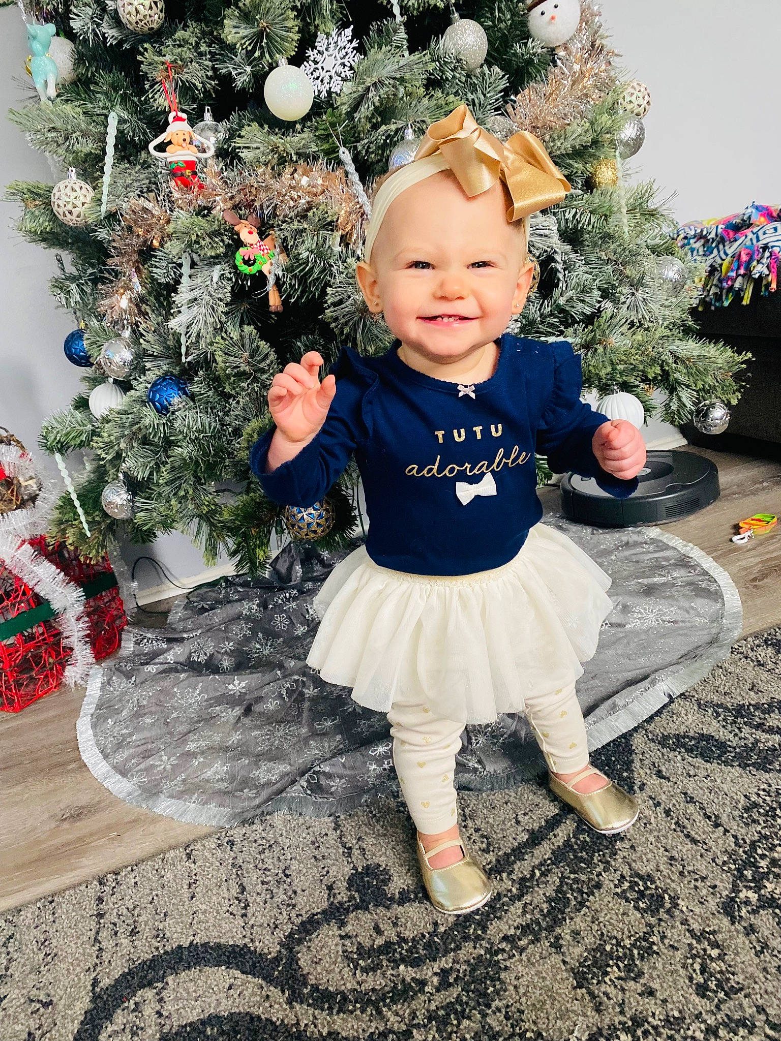 Ansley is registered to the contest to win money with this photo: baby, baby_toddler_clothing, child, christmas_decoration, christmas_tree, costume_hat, event, grass, happy, hat, holiday_ornament, human_body, joy, leaf, ornament, people_in_nature, person, plant, smile, standing