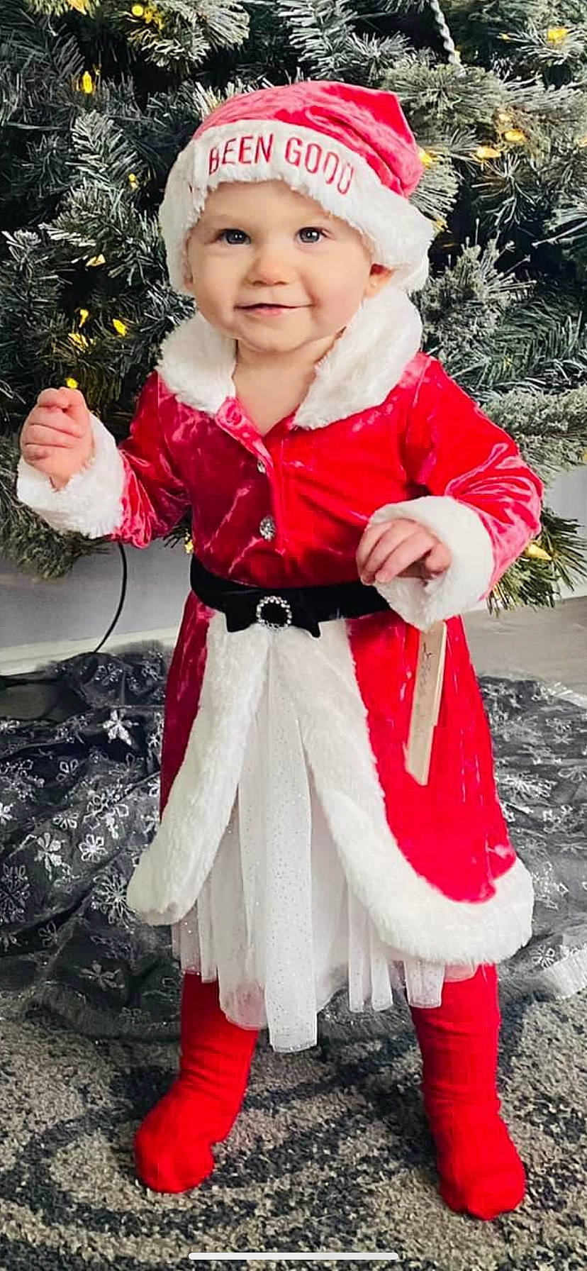 Ansley is registered to the contest to win money with this photo: baby, baby_toddler_clothing, beauty, child, christmas, costume_hat, event, eye, fictional_character, fur, happy, head, headwear, joy, outerwear, person, pink, primate, red, sleeve