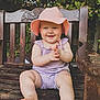 Amelie is registered to the contest to win money with this photo: baby, child, smiling, pink_hat, lavender_romper, clapping_hands, wooden_bench, outdoor, greenery, sunhat, cute, happy, sitting, legs, feet, summer, nature, portrait, toddler, playful