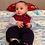 Priyansh Minhas joined the competition — help win amazing prizes! baby, child, bed, pillow, vest, bow_tie, socks, bedspread, pattern, indoor, cute, expression, clothing, person, infant, sitting, furniture, decor, portrait, home