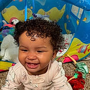 Everleigh joined the competition — help win amazing prizes! toddler, child, smiling, curly_hair, play_tent, plush_toys, doll, carpet, indoor, baby_clothes, earring, happy, young_child, cute, playtime, colorful, toy, infant, person, portrait