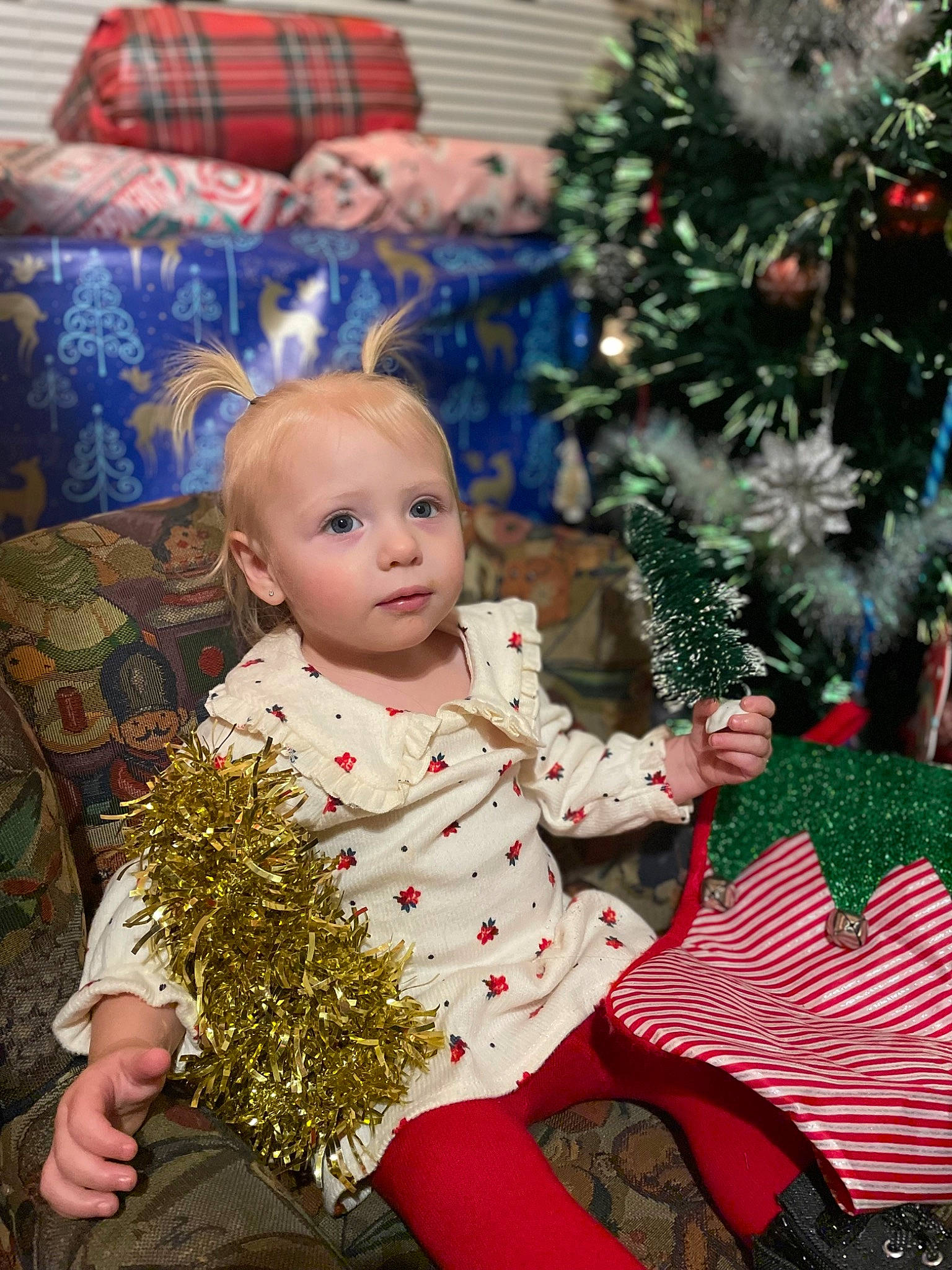 Tonya joined the competition — help win amazing prizes! baby, baby_toddler_clothing, child, christmas_decoration, christmas_ornament, christmas_tree, event, green, happy, head, holiday, people, people_in_nature, person, photograph, plant, sitting, snapshot, tartan, toddler