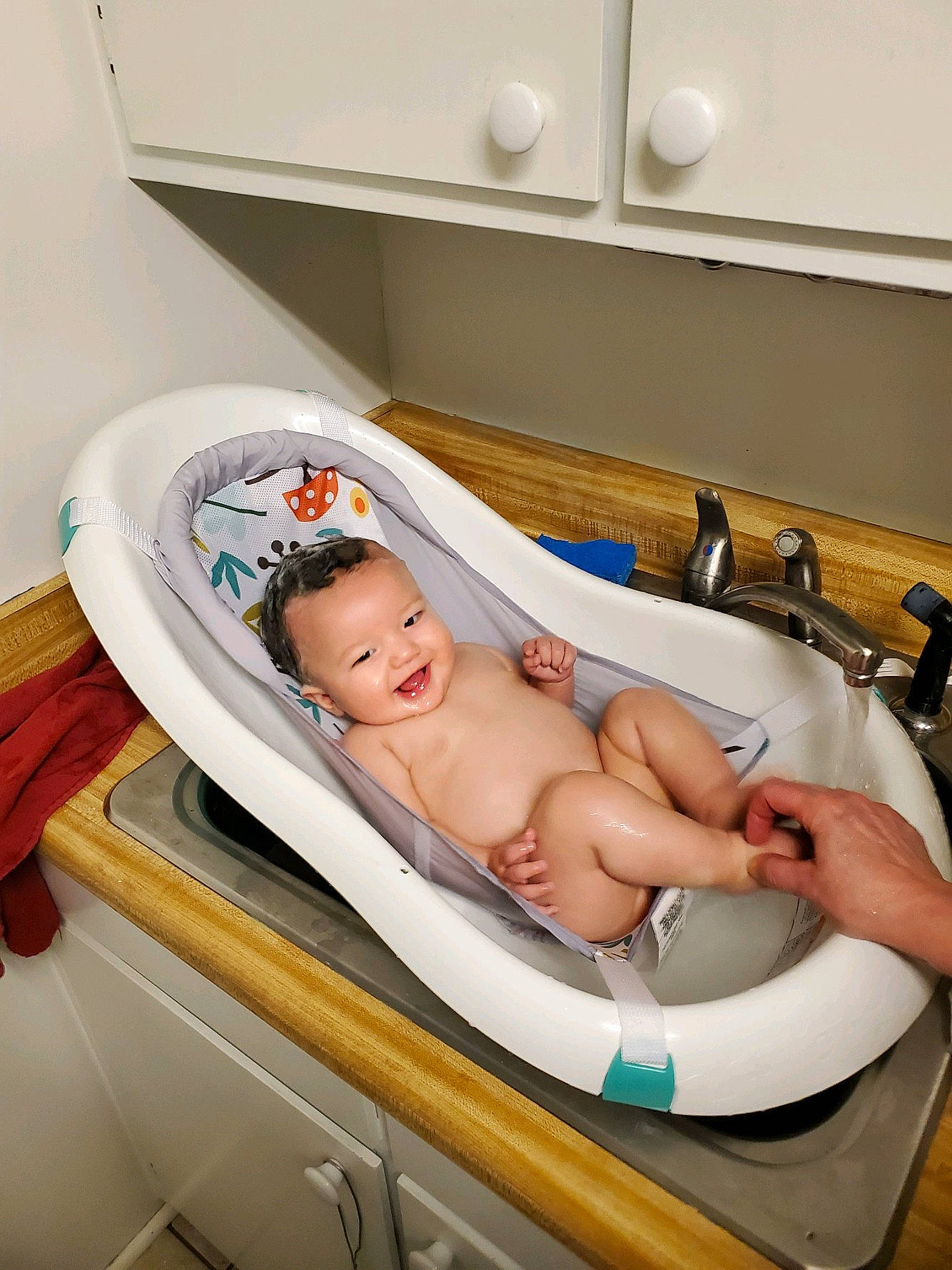 Andrew is registered to the contest to win money with this photo: baby, baby_products, baby_safety, bathing, bathroom, child, cleanliness, comfort, event, health_care, hospital, human_leg, joy, leisure, medical_equipment, person, room, service, sink, thigh