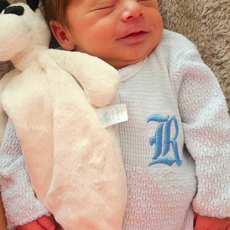 Lyan is registered to the contest to win money with this photo: baby, blanket, child, closeup, cozy, cute, embroidery, hand, indoor, infant, knitted_outfit, newborn, peaceful, plush_toy, portrait, relaxation, resting, sleeping, smiling, soft_texture