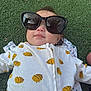 baby, child, sunglasses, grass, outdoor, onesie, bee_pattern, cute, infant, face, smile, bubble, clothing, relaxed, lying_down, toddler, nature, sunlight, head, portrait