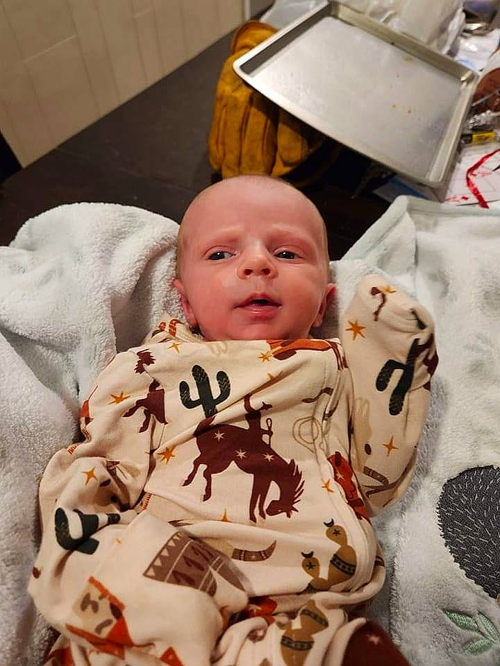 Callahan is registered to the contest to win money with this photo: baby, baby_toddler_clothing, carmine, cheek, child, comfort, happy, linens, pattern, person, room, sitting, sleeve, toddler, wood