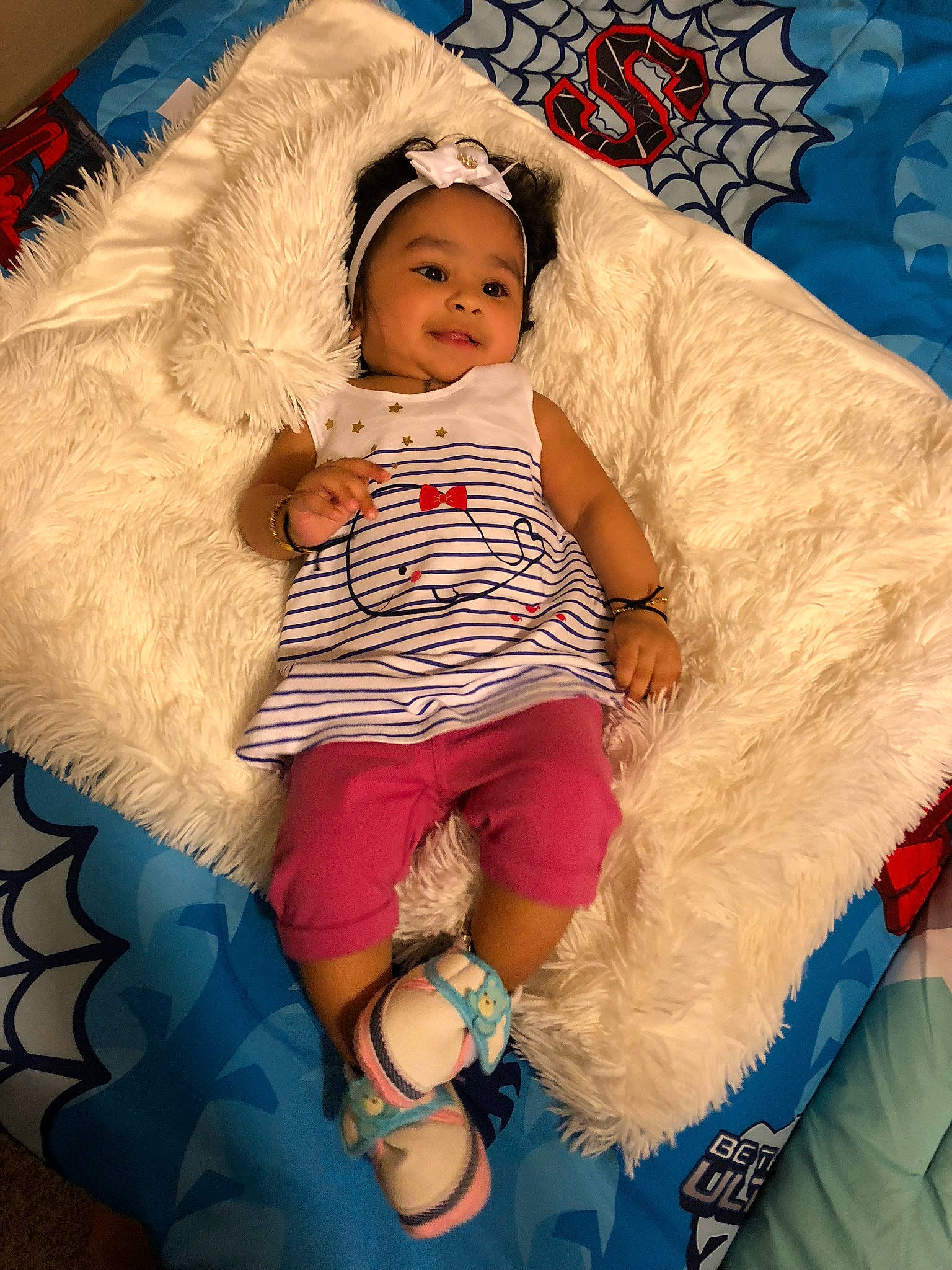 Shanvi is registered to the contest to win money with this photo: baby, baby_toddler_clothing, blue, child, comfort, event, eye, face, fun, happy, headgear, headwear, lap, linens, pattern, person, pink, sitting, sleeve, textile