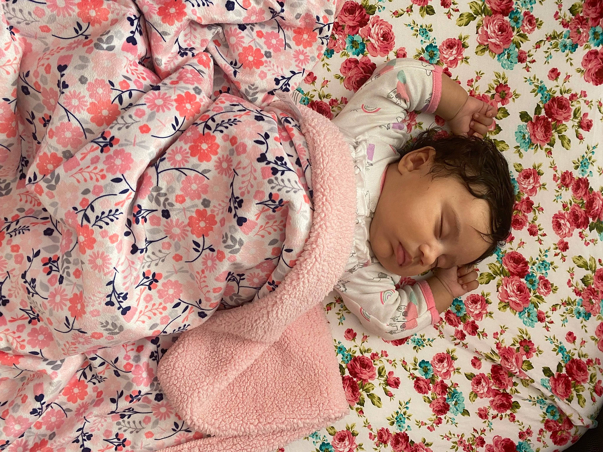Ariella is registered to the contest to win money with this photo: baby, bed_sheet, bedding, bedtime, child, comfort, flooring, flower, happy, linens, magenta, mammal, pattern, peach, person, petal, pink, room, sleeve, toddler