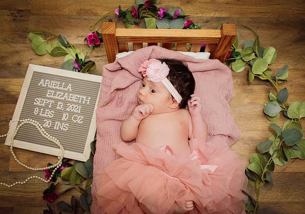 Ariella is registered to the contest to win money with this photo: art, artificial_flower, child, comfort, cut_flowers, floral_design, flower, flower_arranging, font, grass, happy, headpiece, headwear, illustration, linens, person, petal, pink, plant, publication